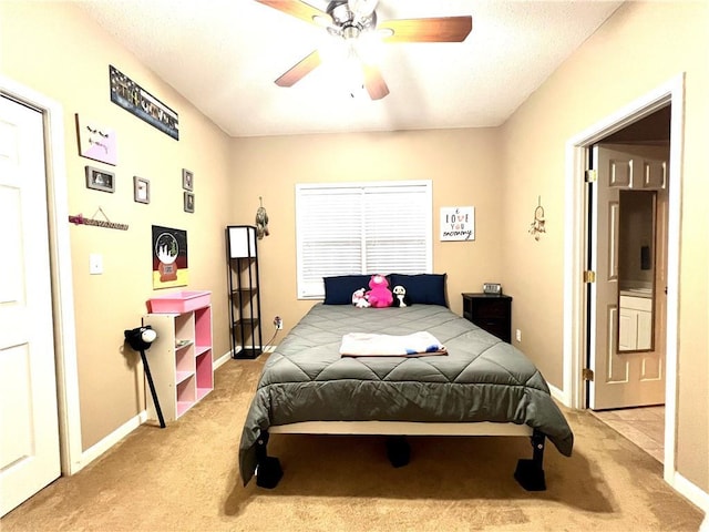 bedroom with baseboards, a ceiling fan, and light carpet