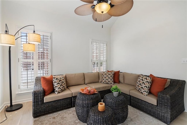 living room featuring a wealth of natural light, ceiling fan, and wood finished floors