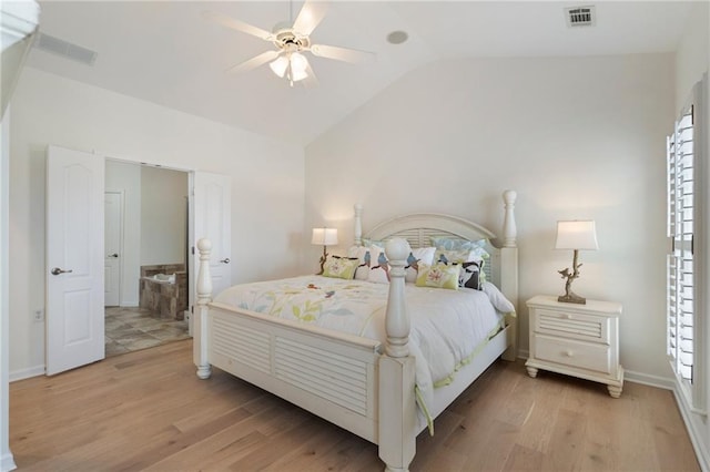 bedroom with visible vents, light wood-type flooring, and vaulted ceiling