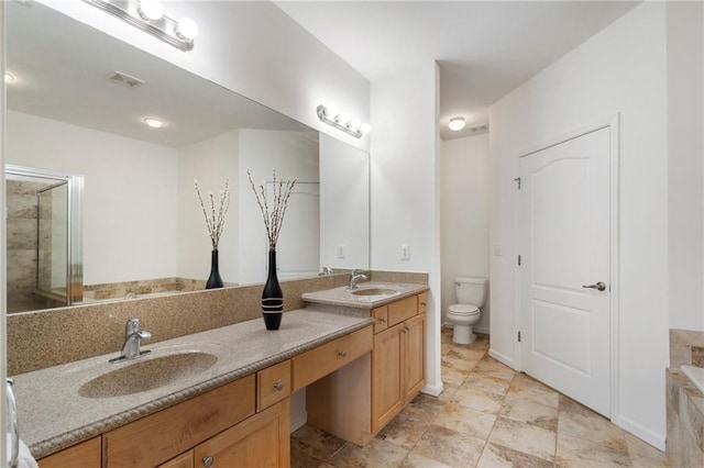 bathroom featuring visible vents, toilet, a sink, double vanity, and a bathtub