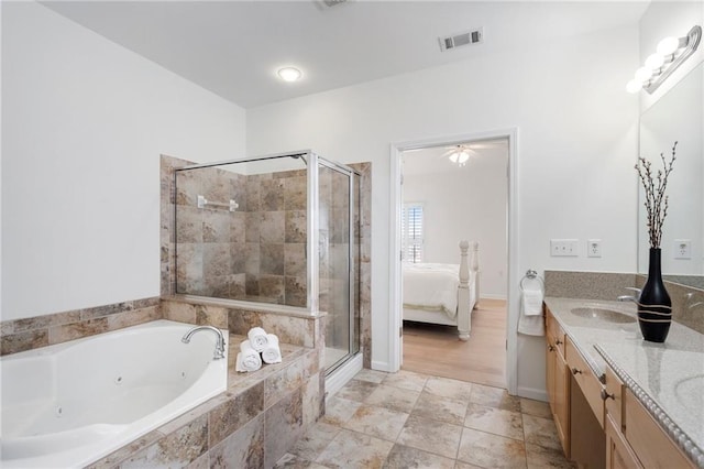 ensuite bathroom with visible vents, a shower stall, ensuite bathroom, and a sink