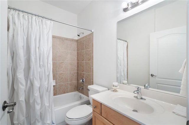 bathroom with toilet, vanity, and shower / bath combo