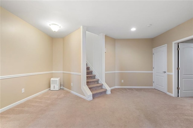 below grade area featuring stairway, recessed lighting, baseboards, and carpet floors