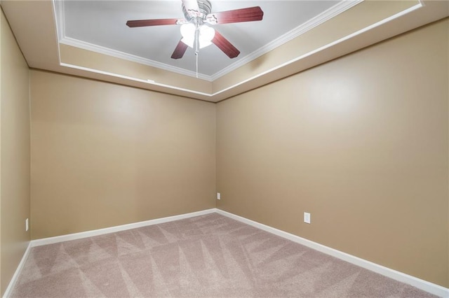 carpeted empty room featuring baseboards, ornamental molding, and a ceiling fan