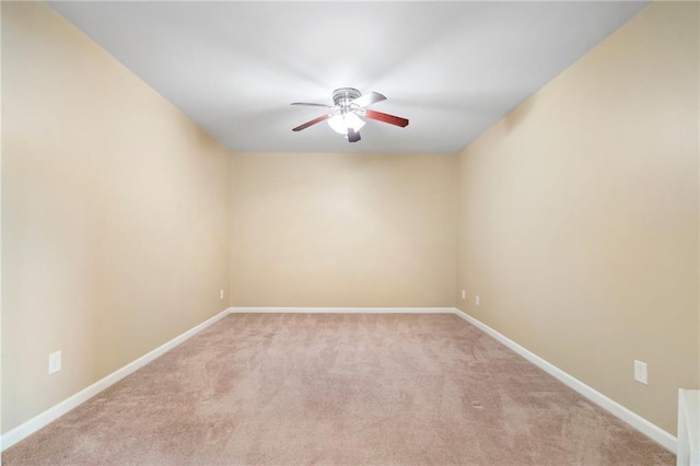 unfurnished room with baseboards, light colored carpet, and ceiling fan