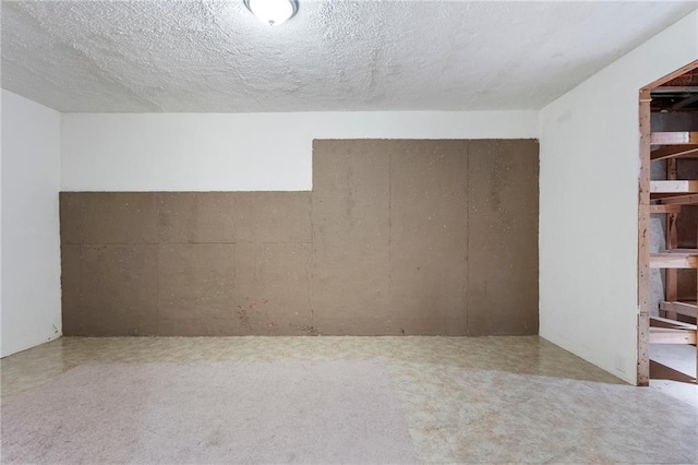 unfurnished room with a textured ceiling