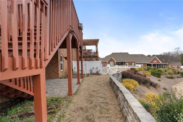 view of yard featuring a patio area, fence, and a gate