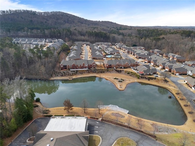 birds eye view of property featuring a residential view, a forest view, and a water and mountain view