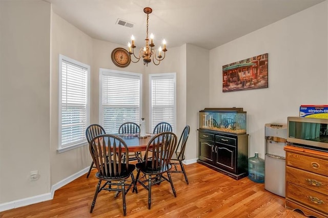 2545 Gatewater Ct, Cumming, GA 30040 - dining room with a chandelier, light wood finished floors, and baseboards