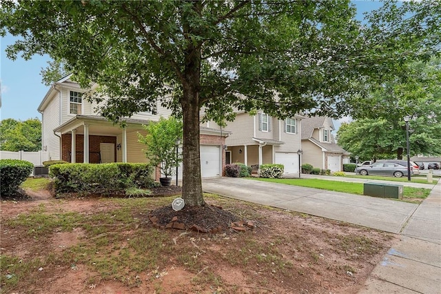 2545 Gatewater Ct, Cumming, GA 30040 - obstructed view of property with a garage, concrete driveway, and covered porch