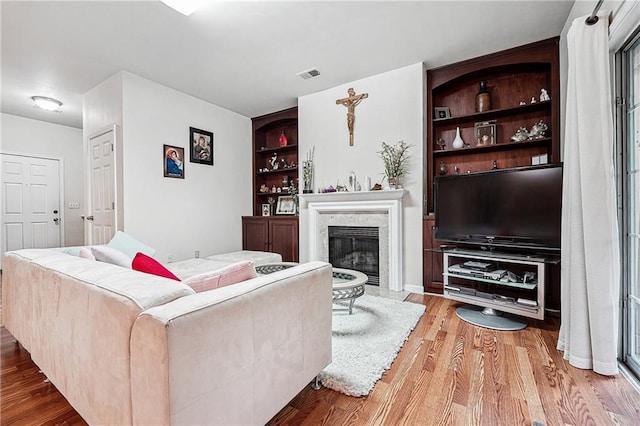 2545 Gatewater Ct, Cumming, GA 30040 - living area featuring wood finished floors, a fireplace, and built in shelves