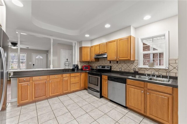 1283 Woodleigh Rd SW, Marietta, GA 30008 - kitchen featuring ceiling fan, sink, tasteful backsplash, kitchen peninsula, and appliances with stainless steel finishes