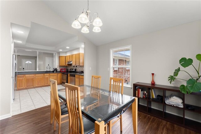 1283 Woodleigh Rd SW, Marietta, GA 30008 - dining room with light wood-type flooring and an inviting chandelier