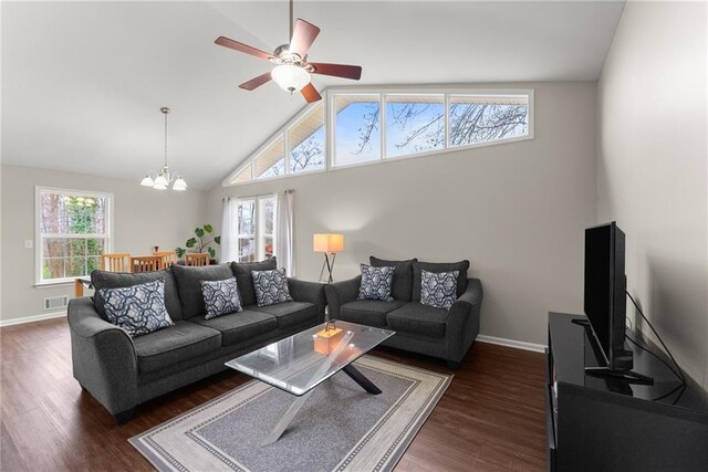 1283 Woodleigh Rd SW, Marietta, GA 30008 - living room featuring ceiling fan with notable chandelier, dark hardwood / wood-style flooring, and vaulted ceiling