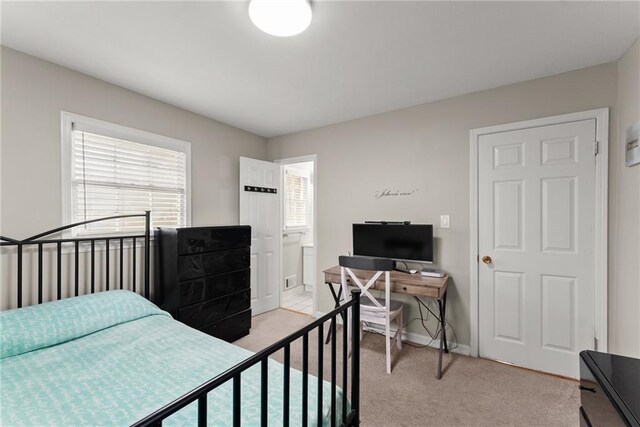 1283 Woodleigh Rd SW, Marietta, GA 30008 - bedroom featuring ensuite bathroom and light carpet