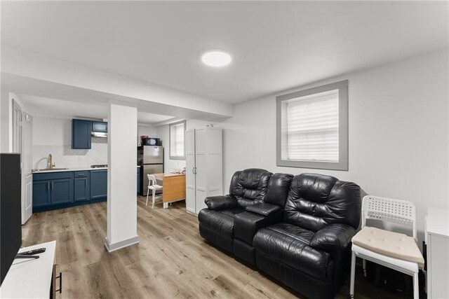 1283 Woodleigh Rd SW, Marietta, GA 30008 - living room featuring light hardwood / wood-style floors, sink, and a wealth of natural light