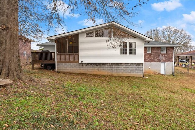 1283 Woodleigh Rd SW, Marietta, GA 30008 - back of house featuring a lawn, a sunroom, and a wooden deck