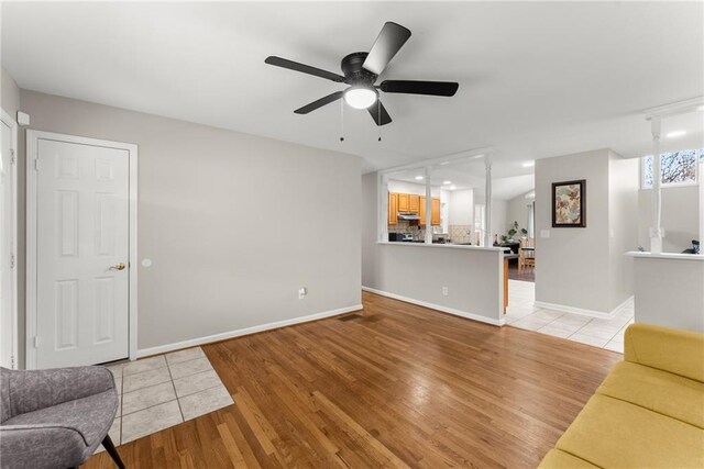 1283 Woodleigh Rd SW, Marietta, GA 30008 - unfurnished living room featuring ceiling fan and light hardwood / wood-style floors