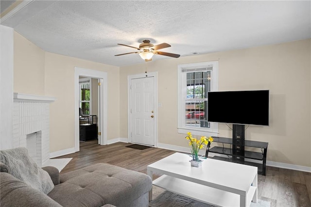 1591 Jonesboro Rd SE, Atlanta, GA 30315 - living area with healthy amount of natural light, a ceiling fan, wood finished floors, and a textured ceiling
