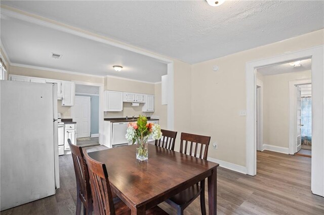 1591 Jonesboro Rd SE, Atlanta, GA 30315 - dining room with baseboards, wood finished floors, and a textured ceiling