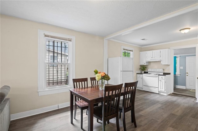 1591 Jonesboro Rd SE, Atlanta, GA 30315 - dining space featuring dark wood-style floors, crown molding, baseboards, and a textured ceiling