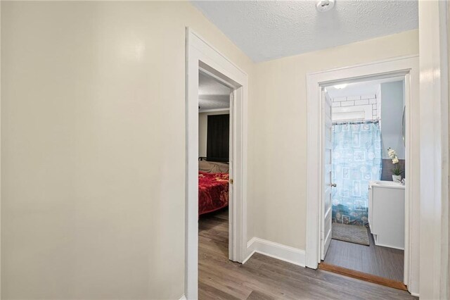 1591 Jonesboro Rd SE, Atlanta, GA 30315 - hall featuring wood finished floors, baseboards, and a textured ceiling