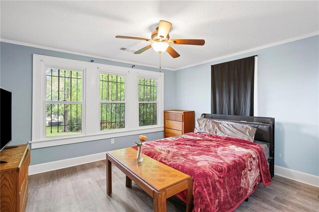 1591 Jonesboro Rd SE, Atlanta, GA 30315 - bedroom with baseboards, wood finished floors, crown molding, a textured ceiling, and a ceiling fan