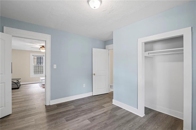 1591 Jonesboro Rd SE, Atlanta, GA 30315 - unfurnished bedroom featuring wood finished floors, baseboards, and a textured ceiling
