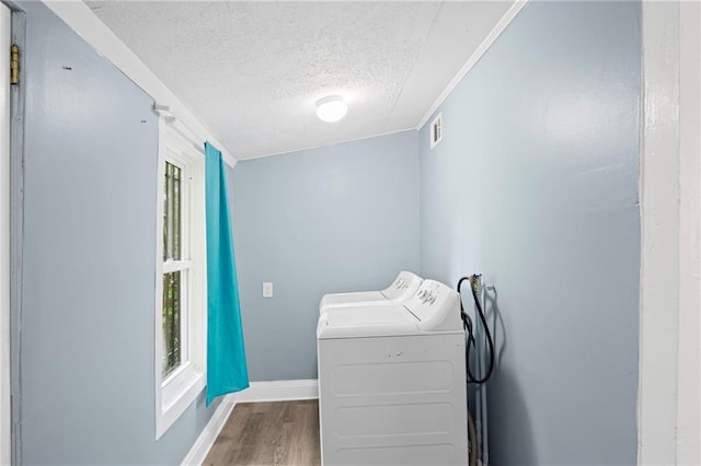 1591 Jonesboro Rd SE, Atlanta, GA 30315 - laundry room with separate washer and dryer, a textured ceiling, wood finished floors, and baseboards