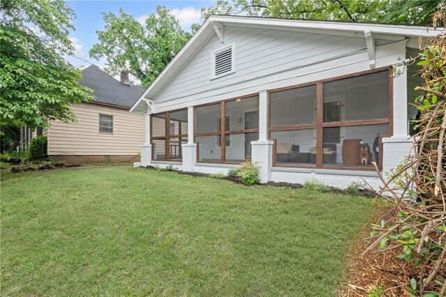 1591 Jonesboro Rd SE, Atlanta, GA 30315 - rear view of property featuring a sunroom and a yard