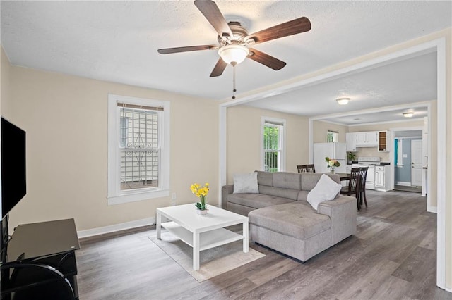 1591 Jonesboro Rd SE, Atlanta, GA 30315 - living room featuring wood finished floors, baseboards, a ceiling fan, and a textured ceiling