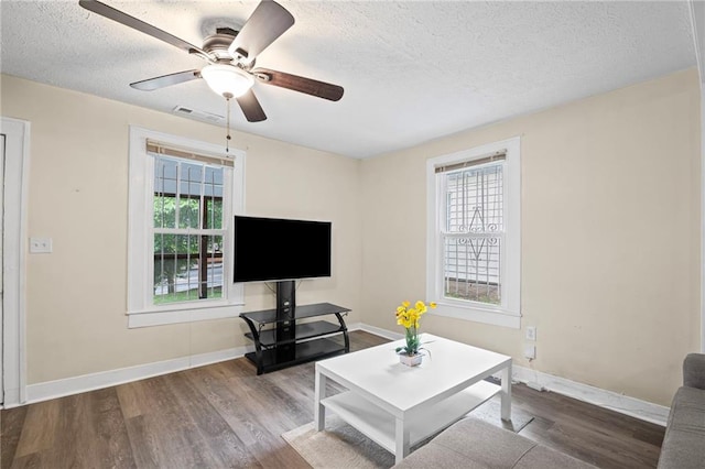 1591 Jonesboro Rd SE, Atlanta, GA 30315 - living area with wood finished floors, plenty of natural light, a textured ceiling, and baseboards