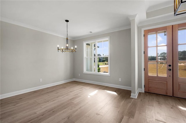 unfurnished dining area featuring hardwood / wood-style floors, a healthy amount of sunlight, and ornamental molding