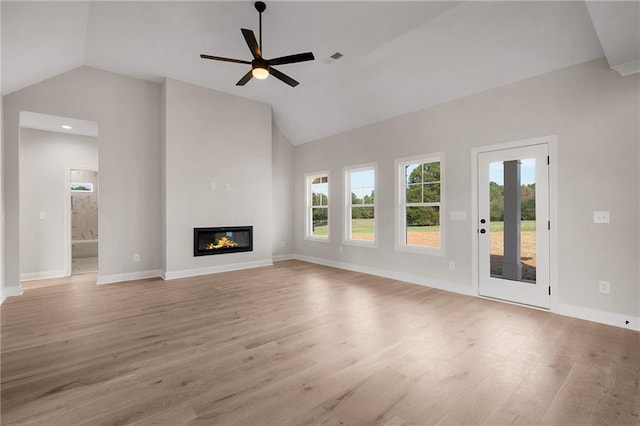 unfurnished living room featuring light hardwood / wood-style floors, ceiling fan, and lofted ceiling