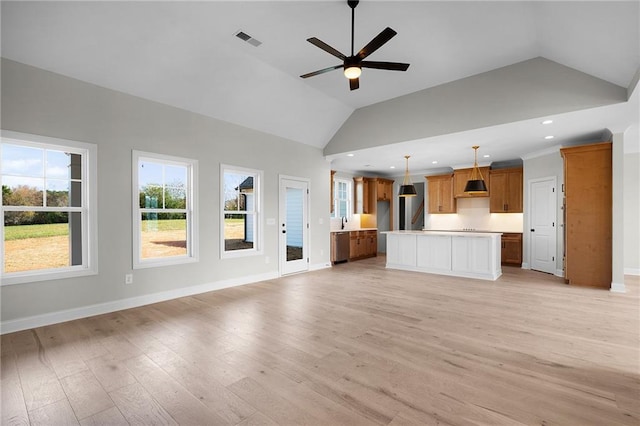 unfurnished living room with ceiling fan, sink, high vaulted ceiling, and light hardwood / wood-style floors