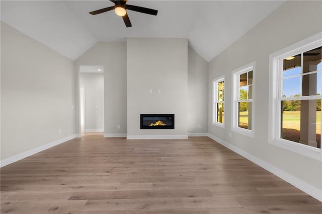 unfurnished living room with ceiling fan, light hardwood / wood-style flooring, and lofted ceiling