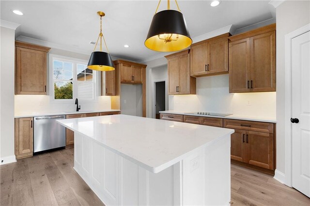 kitchen with pendant lighting, a center island, stainless steel dishwasher, and light hardwood / wood-style floors