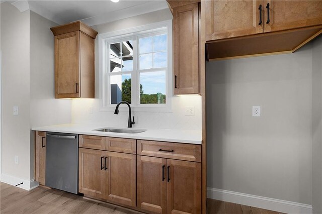 kitchen with dishwasher, light hardwood / wood-style flooring, and sink