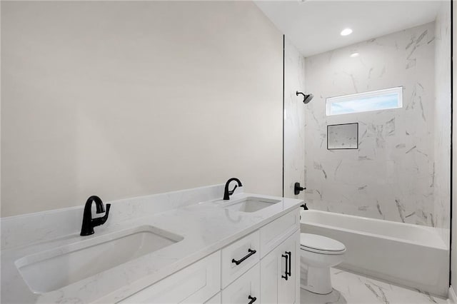 full bathroom featuring vanity, tiled shower / bath combo, and toilet