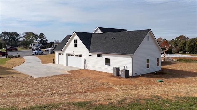 view of home's exterior featuring a garage and central air condition unit