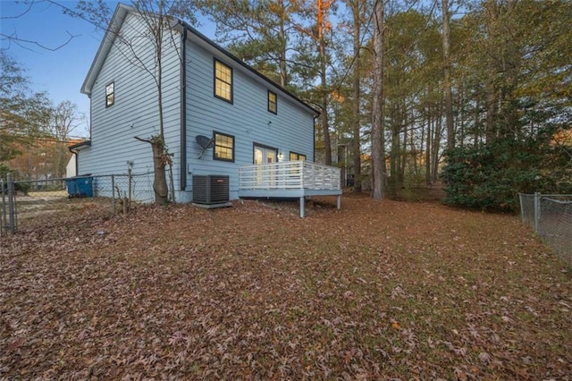 back of house featuring central AC and a deck