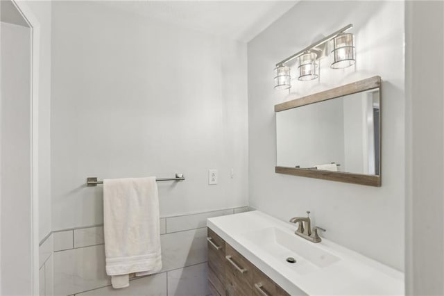 bathroom featuring vanity and tile walls