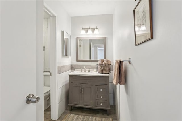 bathroom featuring toilet and vanity