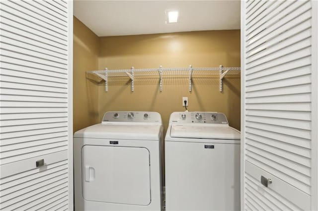 washroom featuring laundry area and washer and clothes dryer