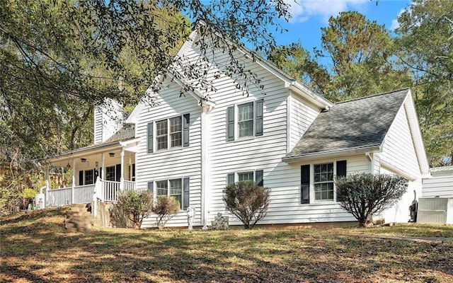 exterior space featuring a porch and a yard