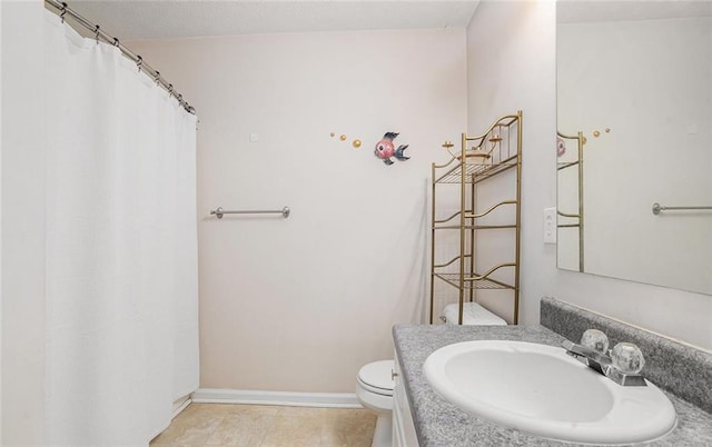 bathroom with tile patterned floors, vanity, and toilet