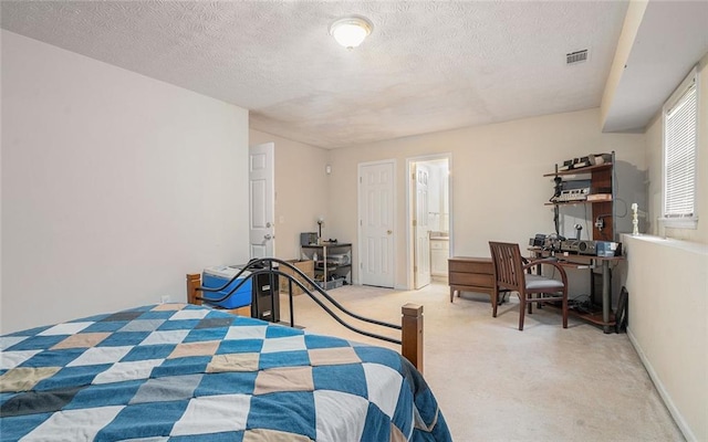 carpeted bedroom featuring connected bathroom and a textured ceiling