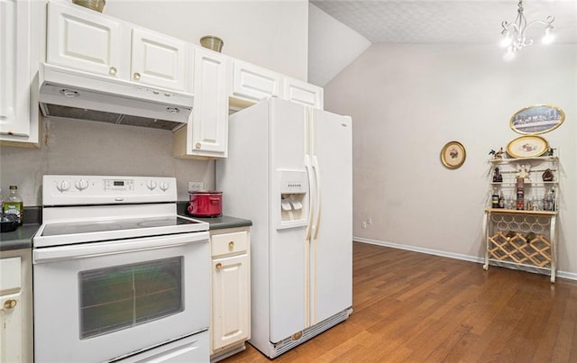 kitchen with a chandelier, vaulted ceiling, white appliances, white cabinets, and hardwood / wood-style flooring