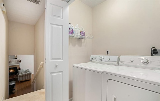 laundry room with hardwood / wood-style floors and washer and dryer