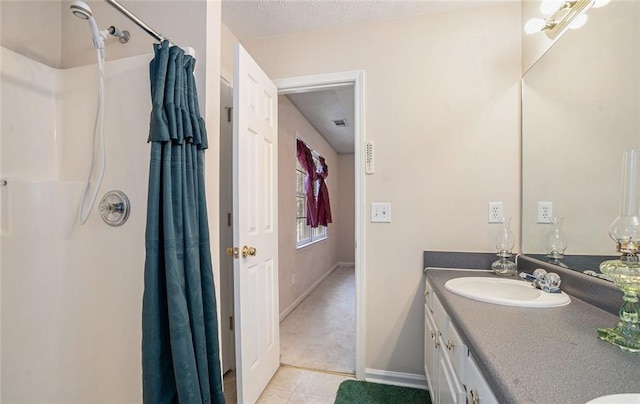 bathroom featuring vanity, tile patterned floors, and walk in shower